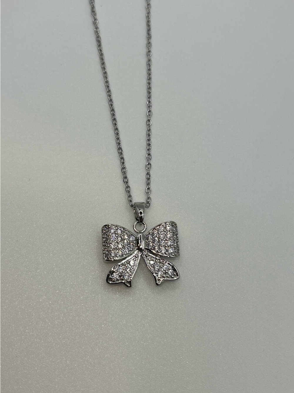 Silver Bow Pendant Necklace with Clear Crystals
